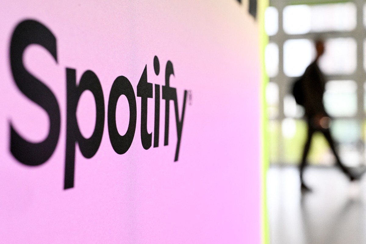 A person walks past a banner with an Spotify logo at the Frankfurt book fair on October 17, 2024. Photo by Kirill KUDRYAVTSEV / AFP