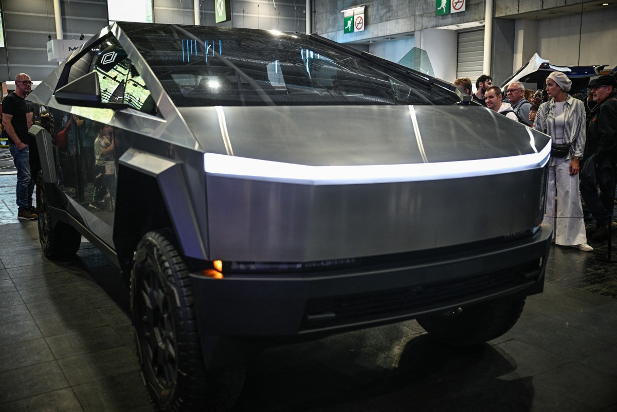 Photo used for demonstration purposes. Visitors look at a Tesla Cybertruck car displayed at the Paris Motor Show at Paris Expo Porte de Versailles in Paris on October 16, 2024. Photo by JULIEN DE ROSA / AFP.
