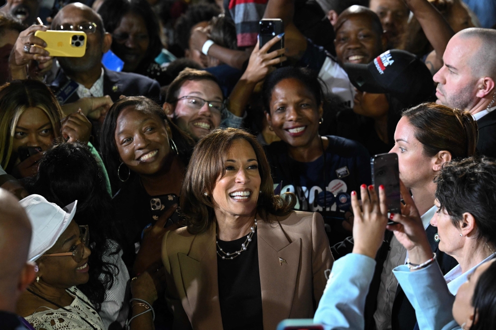 US Vice President and Democratic presidential candidate Kamala Harris takes a picture with supporters at the end of a campaign rally at the James R Hallford Stadium in Clarkston, Georgia on October 24, 2024. (Photo by Drew Angerer / AFP)