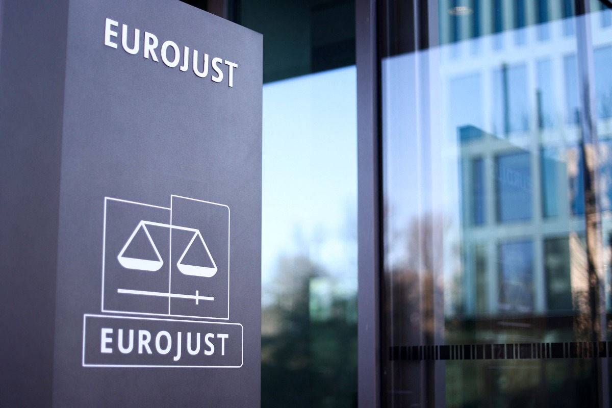 This general view shows the logo of EU Agency for Criminal Justice Cooperation (Eurojust) at the entrance to Eurojust headquarters in The Hague on February 8, 2023. Photo by Kenzo TRIBOUILLARD / AFP