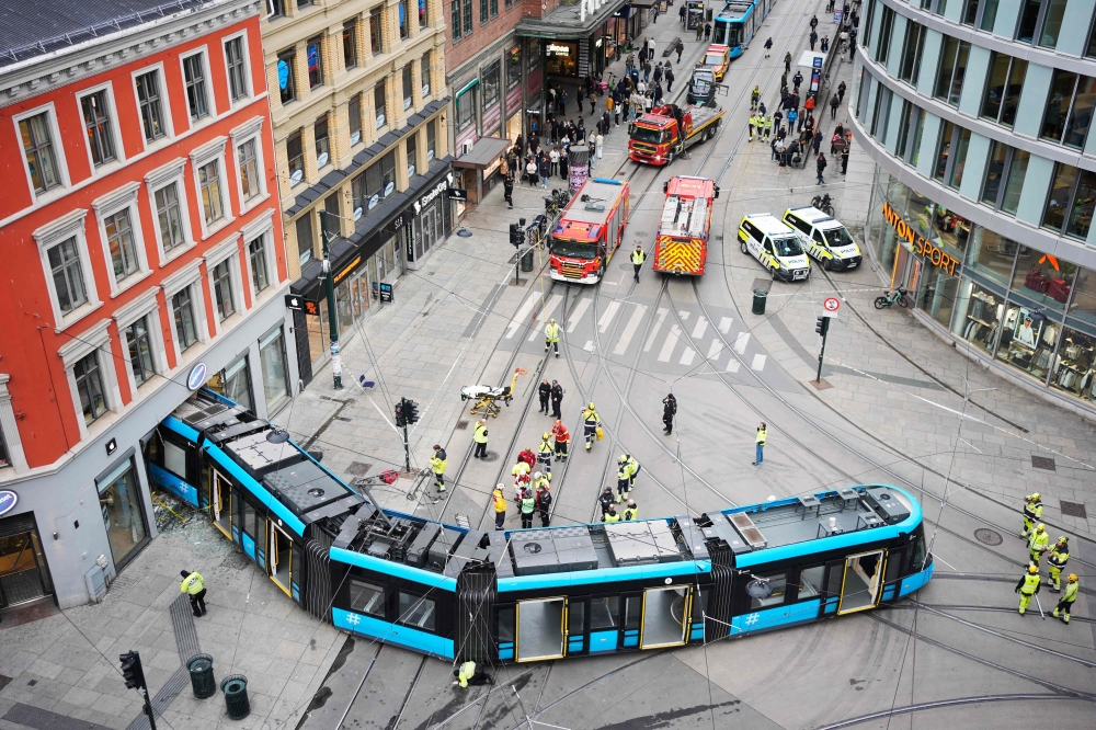 An overall view shows a derailed tram that has driven into a building in a busy street in the center of Oslo, Norway on October 29, 2024. Photo by Terje Pedersen / NTB / AFP