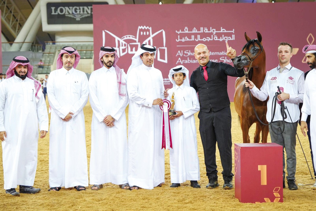 Connections of the winning horses pose for photos.