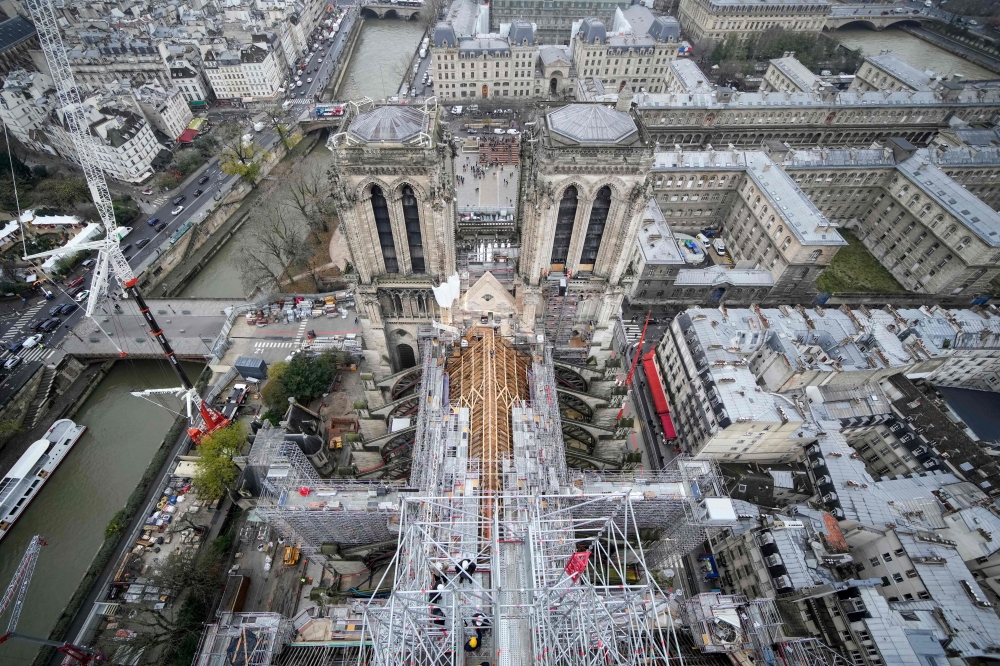 (Files) This photograph taken from atop the Notre-Dame de Paris Cathedral shows the structure of the building during reconstruction work, on the Ile de la Cite in Paris, on December 8, 2023. (Photo by Christophe Ena / POOL / AFP)