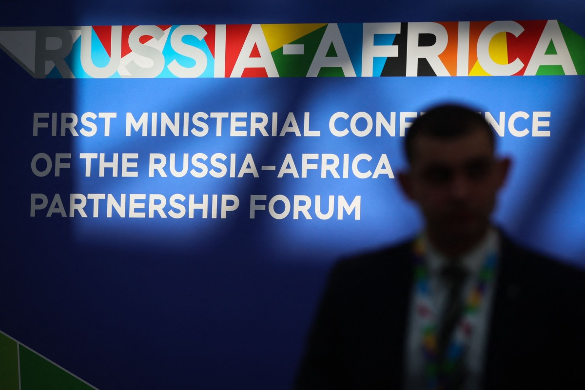 A participant walks past branding for the Russia-Africa partnership forum at Sirius University ahead of a meeting of its foreign ministers in Sochi on November 9, 2024. (Photo by STRINGER / AFP)
