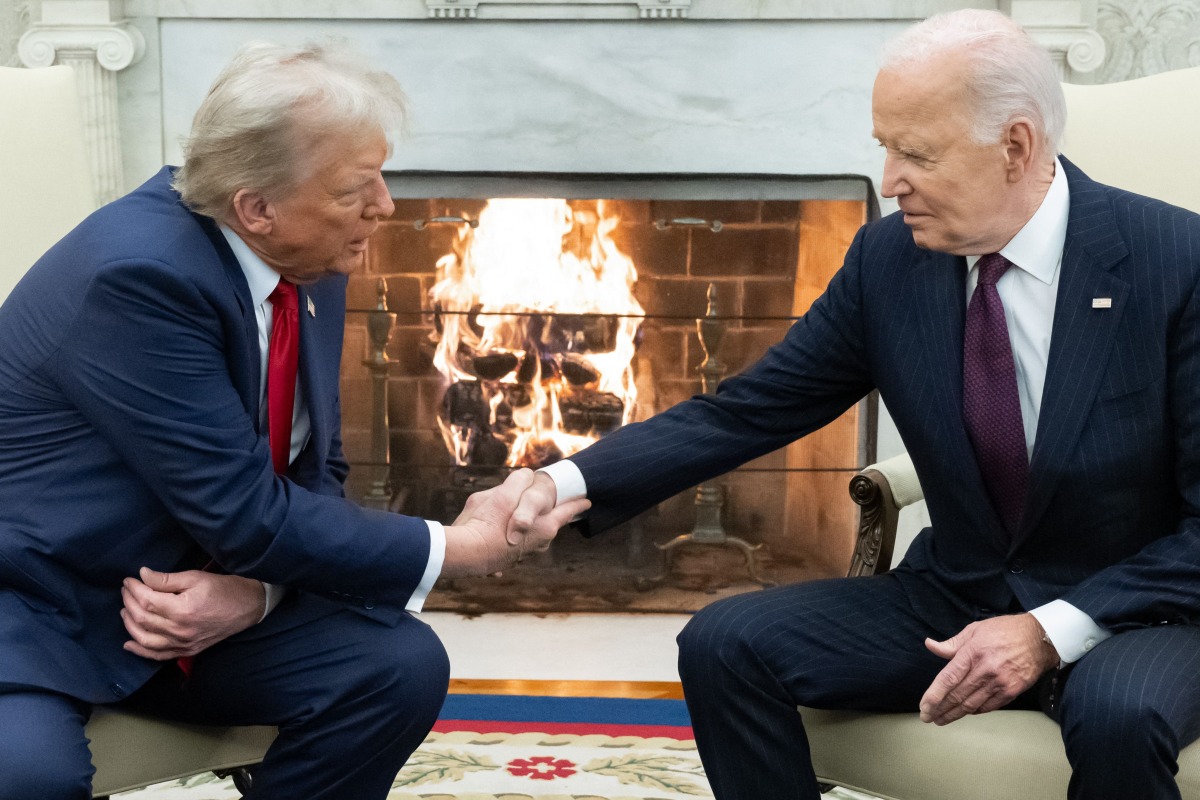 US President Joe Biden shakes hands with US President-elect Donald Trump during a meeting in the Oval Office of the White House in Washington, DC, on November 13, 2024. (Photo by SAUL LOEB / AFP)

