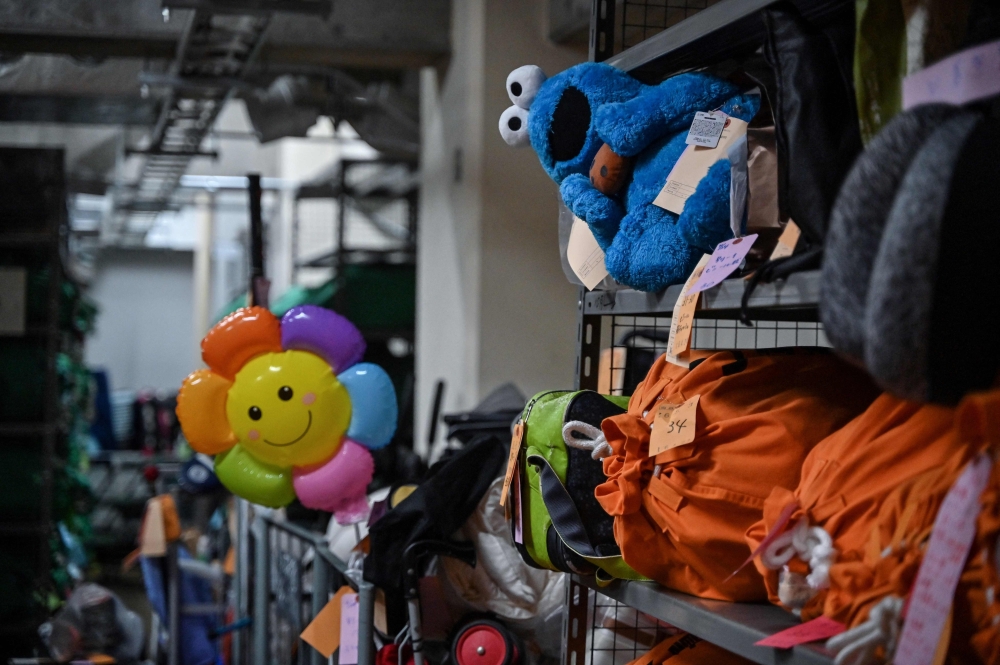 Items - all organised from where and when they were lost, sitting on shelves at the Tokyo Metropolitan Police Department Lost and Found Centre in the Iidabashi area of central Tokyo. (Photo by Richard A. Brooks / AFP)