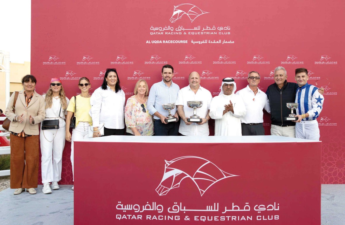 The connections of Hamam celebrate with their trophies after winning the Lekhraib Cup.