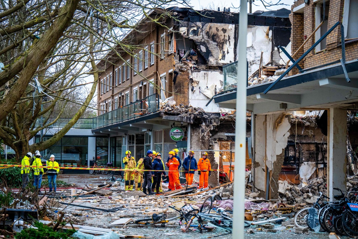 Rescuers work on the site where an explosion and fire destroyed an apartment block, killing at least six people, on the Tarwekamp in The Hague on December 9, 2024. Photo by Josh Walet / ANP / AFP