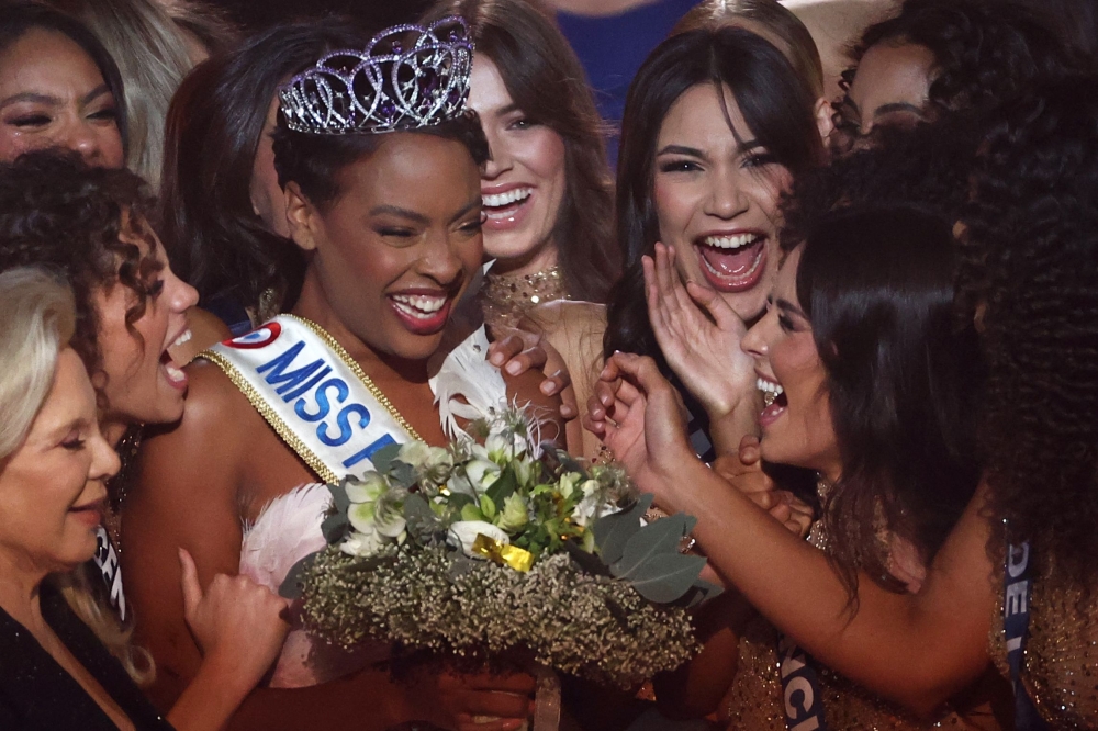 Newly elected Miss France 2025 Angelique Angarni-Filopon celebrates winning the Miss France 2025 beauty pageant, on December 14, 2024. (Photo by Romain Perrocheau / AFP)