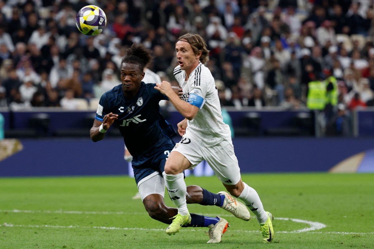 Pachuca's Ecuadorian defender #33 Andres Micolta and Real Madrid's Croatian midfielder #10 Luka Modric vie for the ball during the 2024 FIFA Intercontinental Cup final football match between Spain's Real Madrid and Mexico's Pachuca at the Lusail Stadium in Doha on December 18, 2024. (Photo by KARIM JAAFAR / AFP)