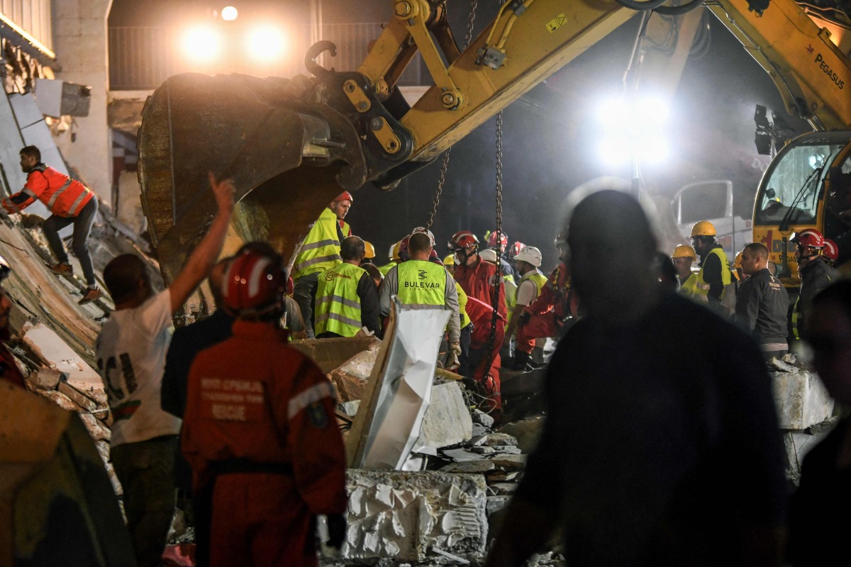Emergency and rescue teams work at the site where a concrete outdoor roof of a train station collapsed in the northern Serbian city of Novi Sad on November 1, 2024. Photo by NENAD MIHAJLOVIC / AFP

