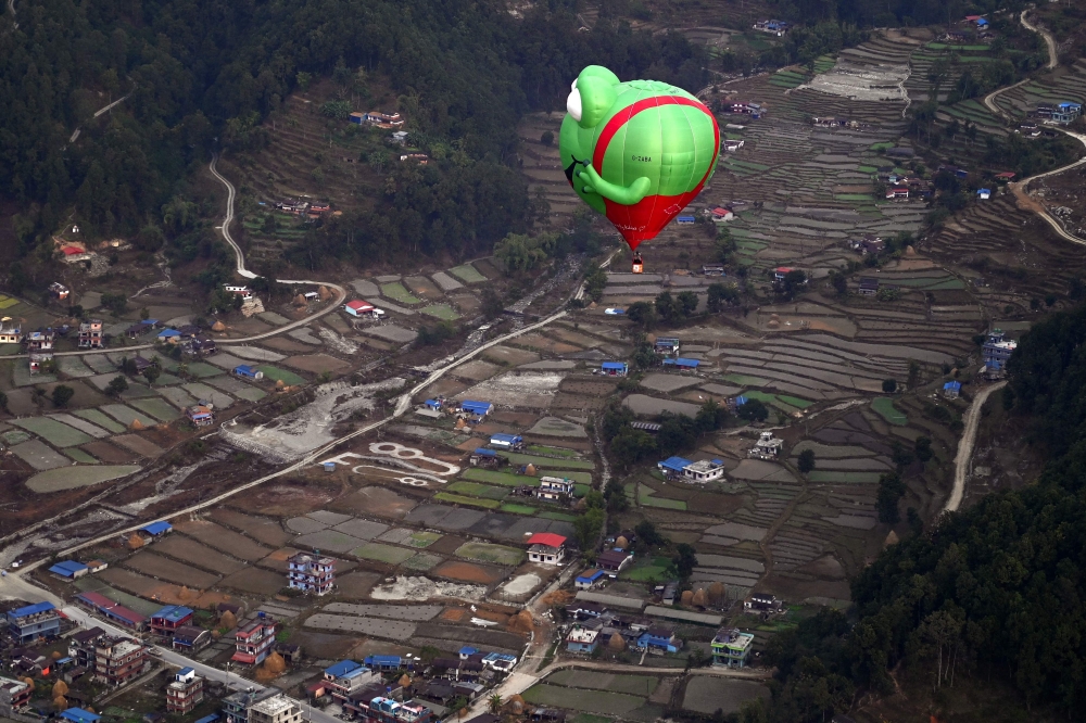 Hot air balloons rise in the sky during the International Hot-Air Balloon festival in Pokhara on December 24, 2024. (Photo by PRAKASH MATHEMA / AFP)
 
