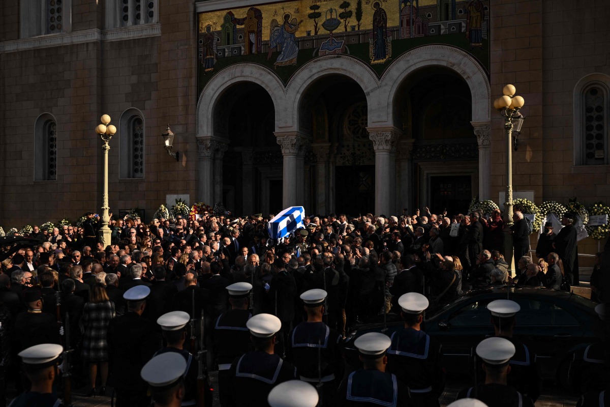 Pallbearers carry the coffin of former Greek Prime Minister Costas Simitis after a mass for his funeral, outside the Metropolitan Cathedral of Athens on January 9, 2025. (Photo by Aris MESSINIS / AFP)
