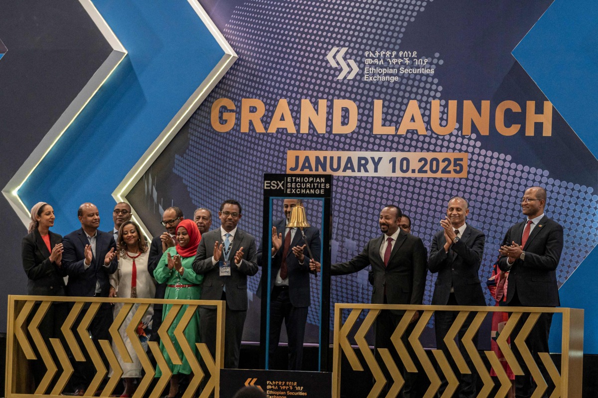Ethiopia's Prime Minister Abiy Ahmed (3rd R) rings the bell during the launch of Ethiopian Securities Exchange in Addis Ababa, Ethiopia, on January 10, 2025. (Photo by Amanuel Sileshi / AFP)
