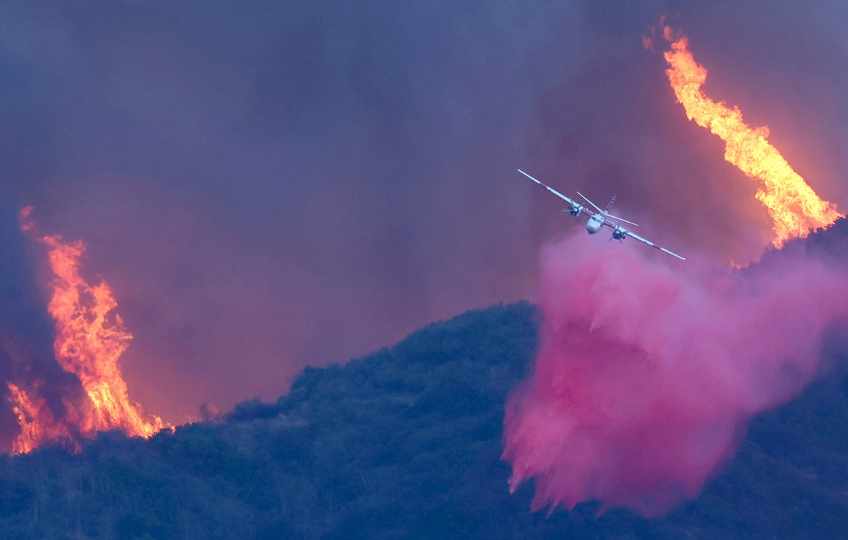 A firefighting aircraft drops the fire retardant Phos-Chek as the Palisades Fire burns amid a powerful windstorm on January 7, 2025 in Pacific Palisades, California. Mario Tama/Getty Images/AFP 