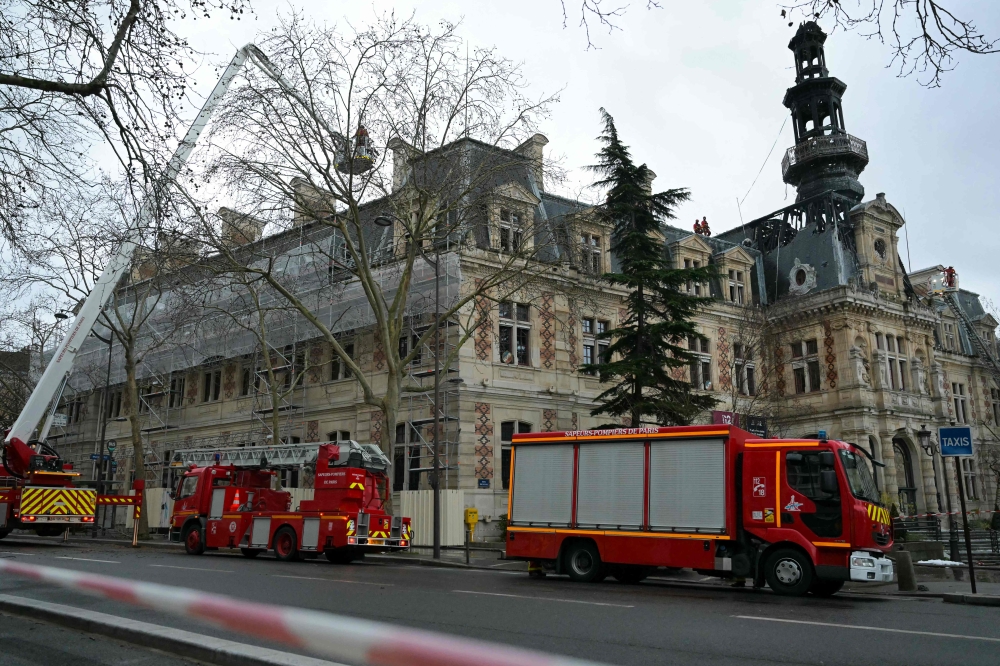 Firefighters vehicles are parked next to the townhall of the 12th district of Paris, on January 27, 2025, after it was hit by a spectacular fire. (Photo by Bertrand Guay / AFP)
 