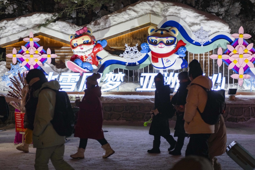 Visitors walk past installations themed on the 2025 Asian Winter Games at China's 
