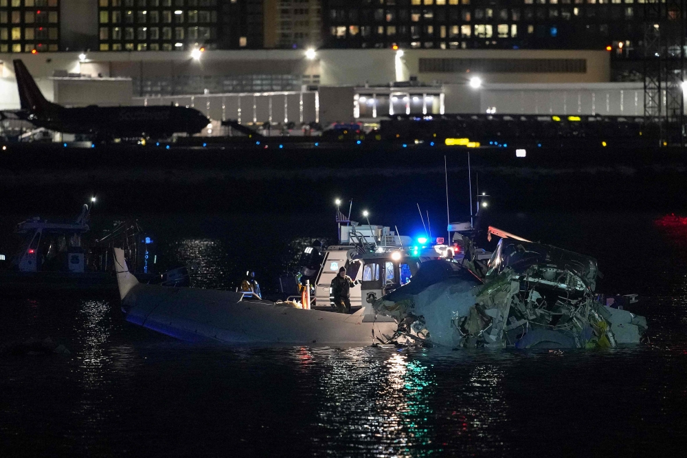 Emergency response units assess airplane wreckage in the Potomac River near Ronald Reagan Washington Airport on January 30, 2025 in Arlington, Virginia. Andrew Harnik/Getty Images/AFP