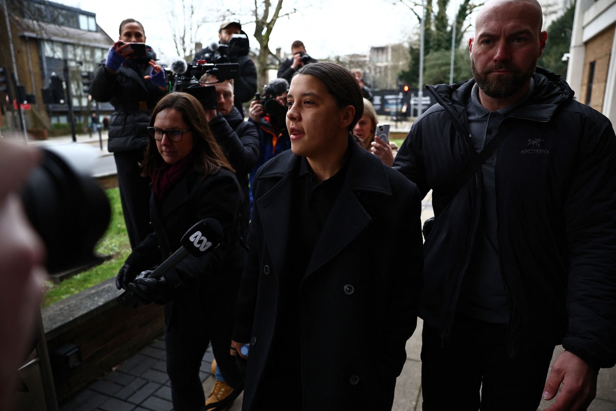 Chelsea's Australian striker Sam Kerr (C) reacts as she arrives at Kingston Crown Court in south London on February 3, 2025, for the start of her trial. (Photo by HENRY NICHOLLS / AFP)
