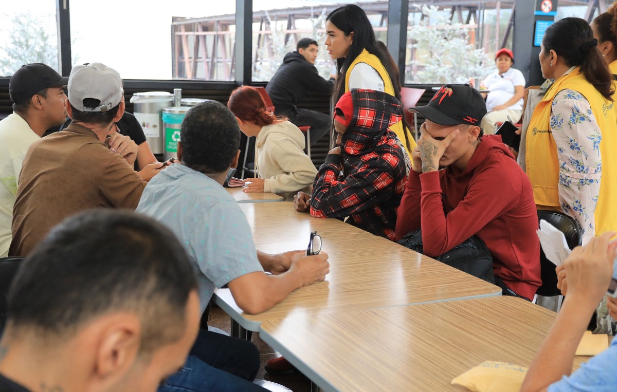 Colombian migrants deported from Panama are received by members of the Social Prosperity Department upon arrival at the Jose Maria Cordova International Airport in Rionegro, Antioquia department, Colombia, on February 13, 2025. (Photo by JAIME SALDARRIAGA / AFP)
