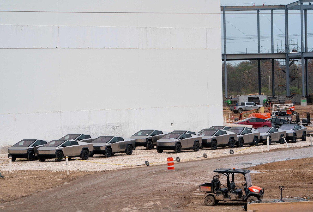 (FILES) Newly manufactured Tesla Cybertrucks are parked outside the company's Giga Texas factory on December 13, 2023, in Austin, Texas. (Photo by SUZANNE CORDEIRO / AFP)
