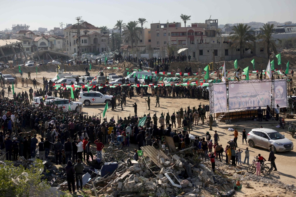 Red Cross vehicles wait at the spot where Hamas is expected to hand over Israeli hostages in Khan Yunis in the southern Gaza Strip on February 15, 2025. (Photo by Bashar Taleb / AFP)
 