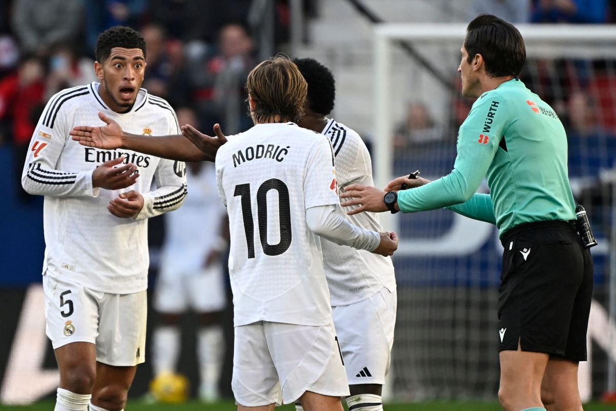 Real Madrid's English midfielder #05 Jude Bellingham reacts to being presented a red card by Spanish referee Munuera Montero during the Spanish league football match between CA Osasuna and Real Madrid CF at El Sadar Stadium in Pamplona on February 15, 2025. (Photo by ANDER GILLENEA / AFP)
