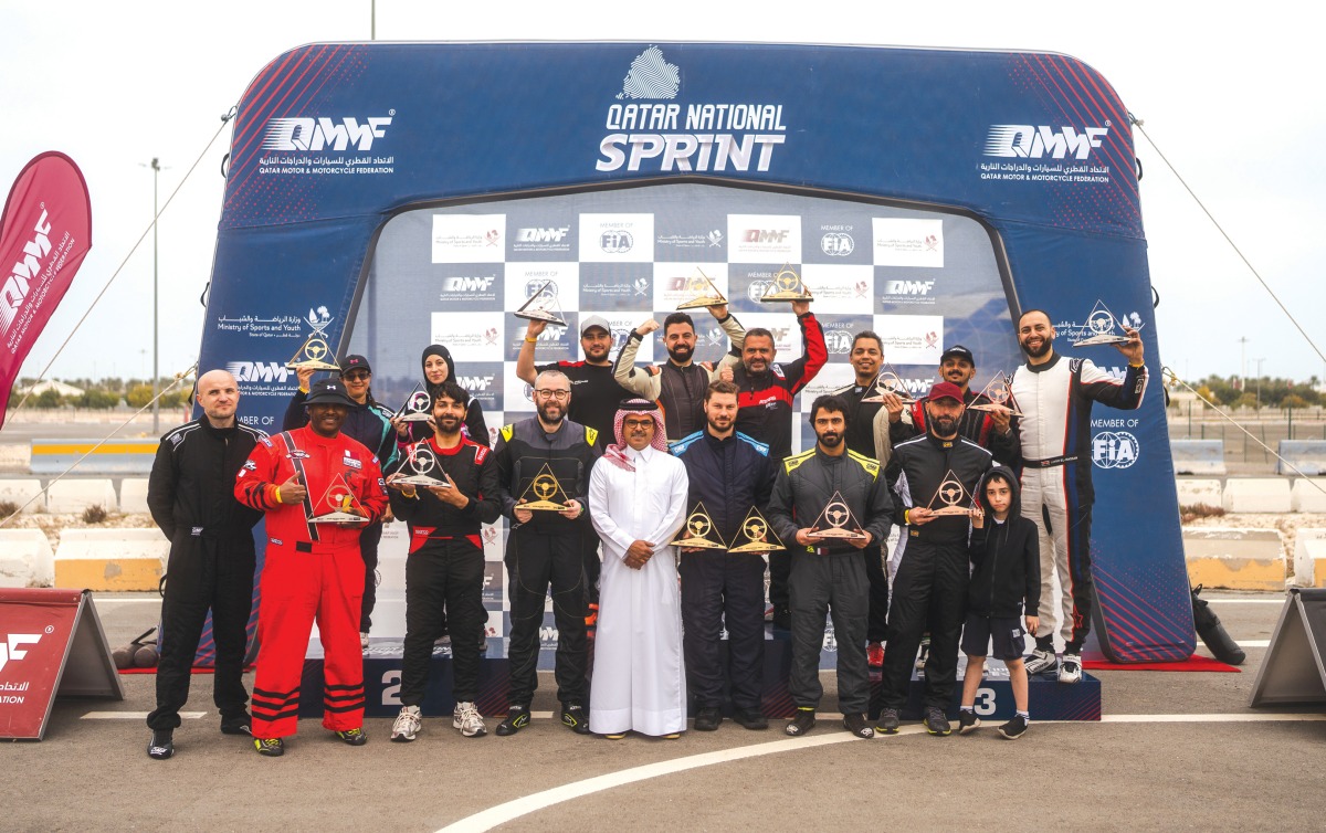 Podium winners of second round pose with their trophies. 