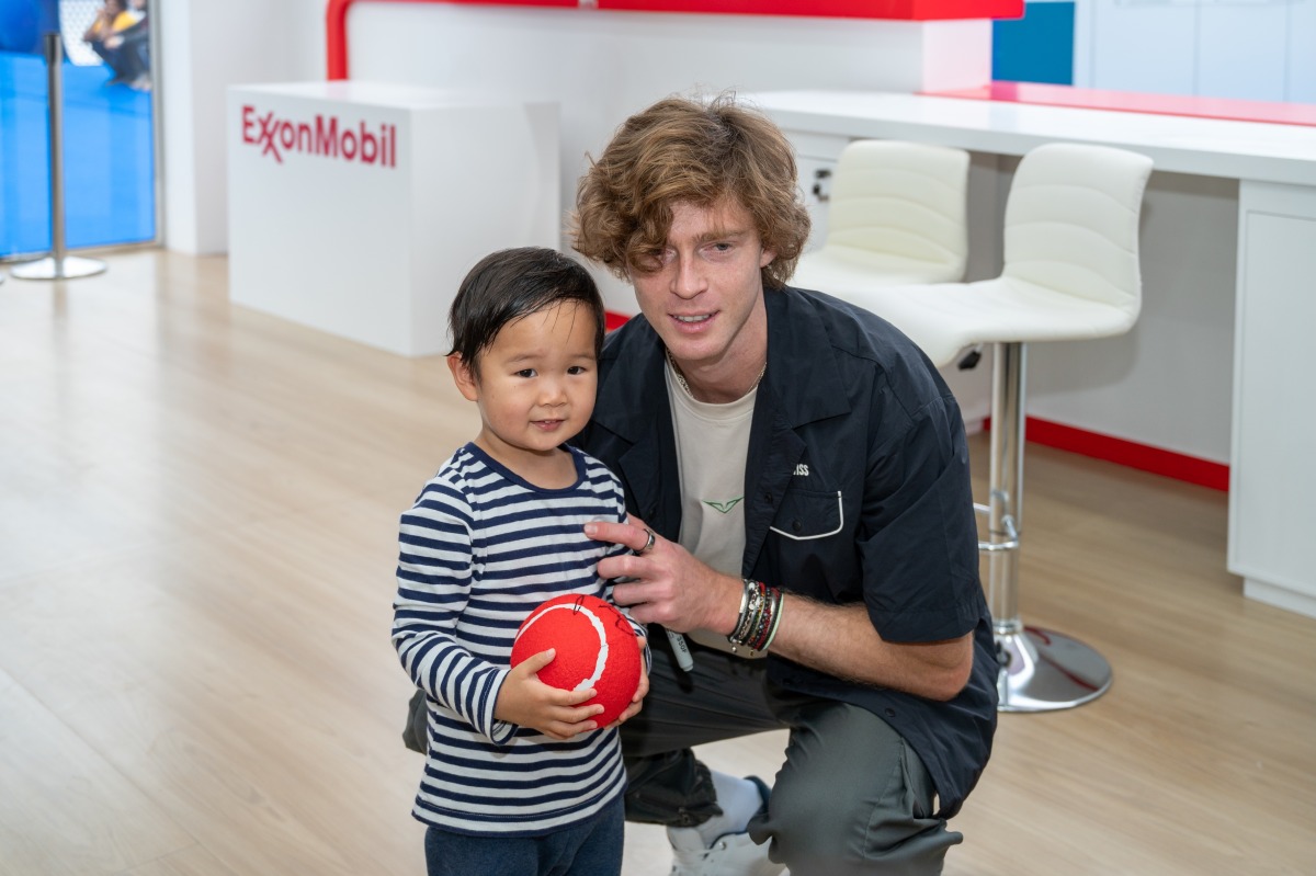 Andrey Rublev with a young fan at the ExxonMobil Qatar Public Village.