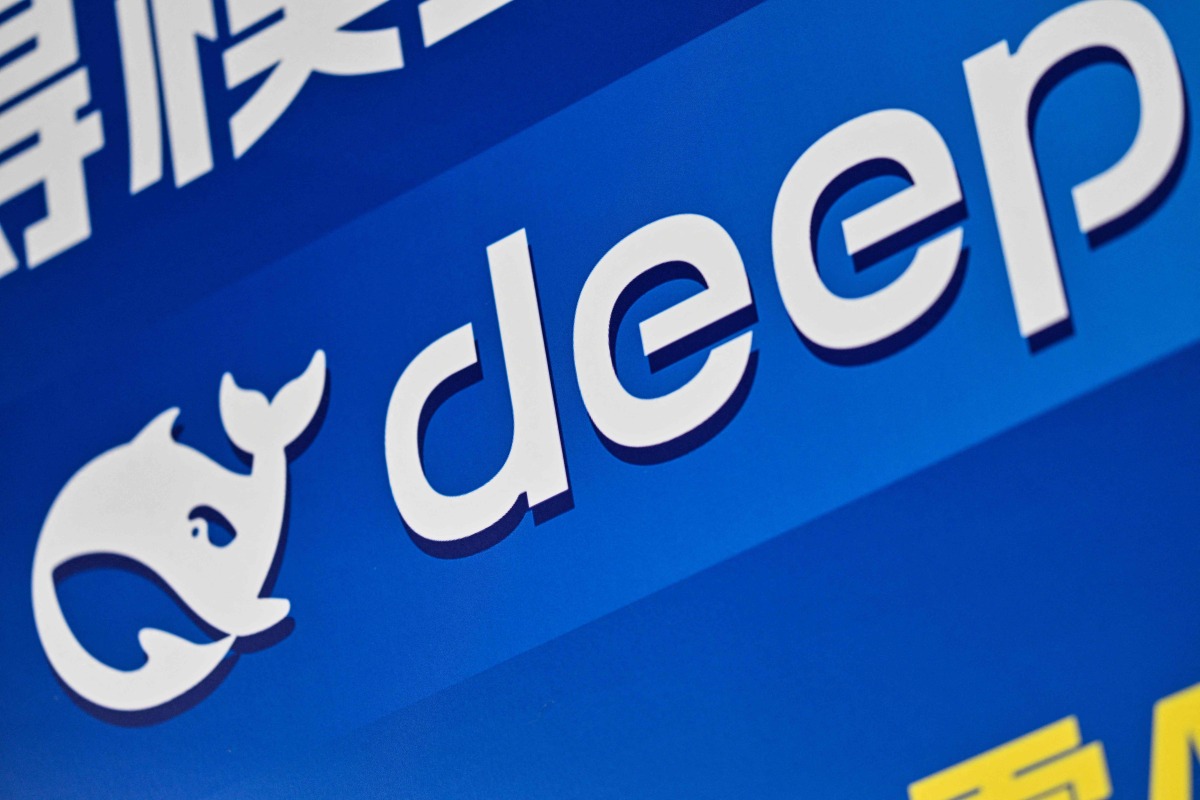 The logo of Deepseek is seen during the Global Developer Conference, organised by the Shanghai AI Industry Association, in Shanghai on February 21, 2025. (Photo by Hector RETAMAL / AFP)