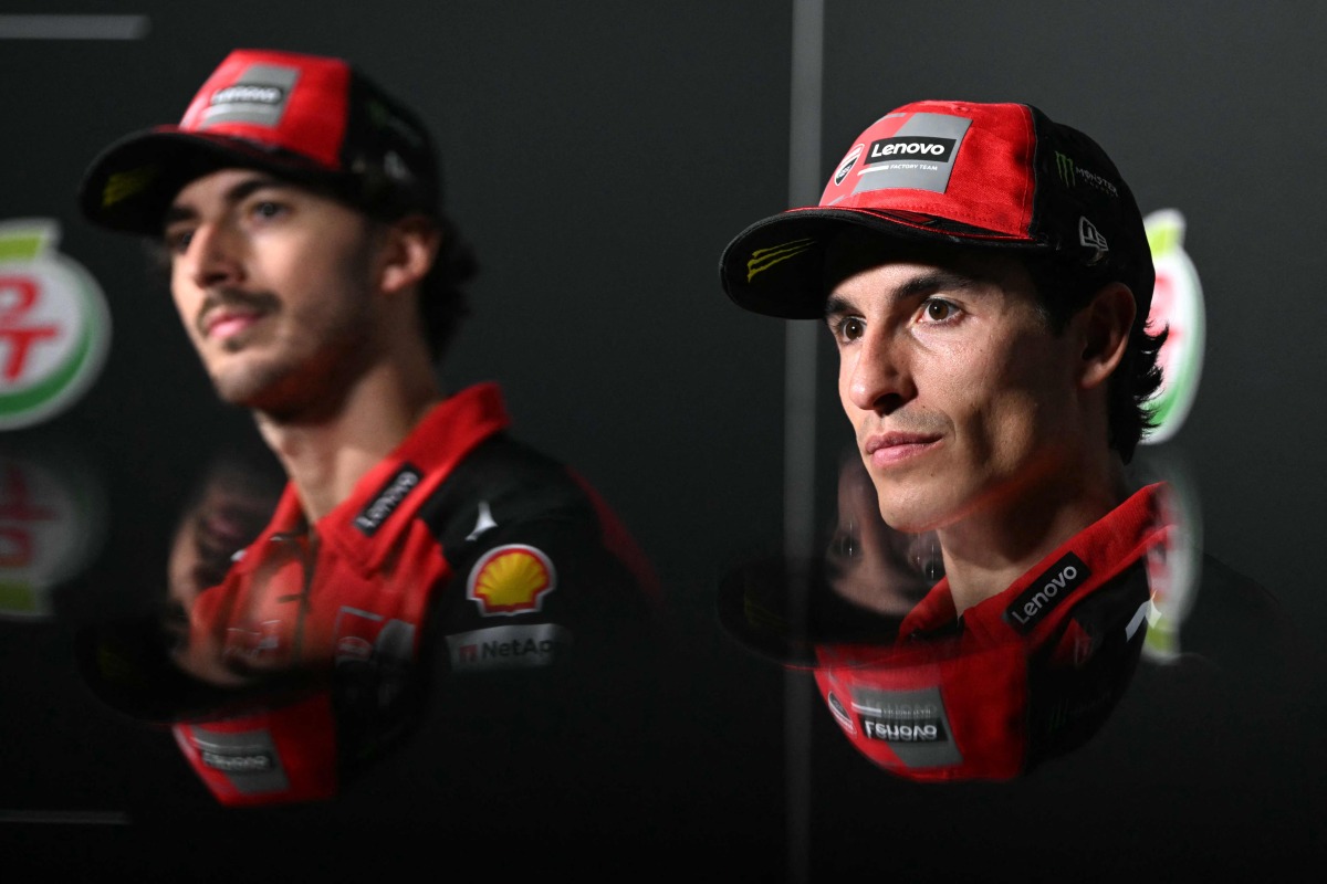 Ducati Lenovo's Italian rider Francesco Bagnaia (L) and Ducati Lenovo's Spanish rider Marc Marquez (R) take part in a press conference ahead of the MotoGP Thailand Grand Prix at the Buriram International Circuit in Buriram on February 27, 2025. (Photo by MOHD RASFAN / AFP)