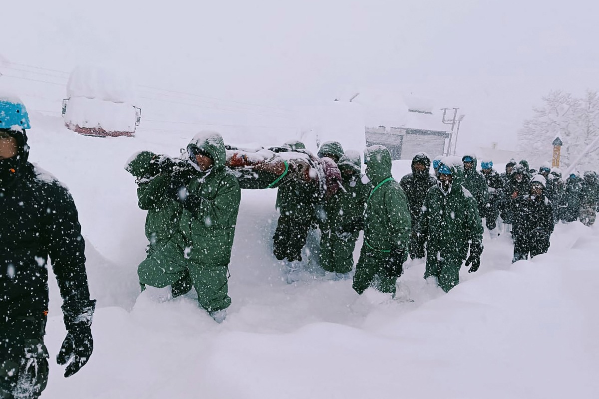 In this handout photo taken and released by the State Disaster Response Force (SDRF) on February 28, 2025, rescuers carry Border Roads Organisation (BRO) workers after an avalanche near Mana village in Chamoli district. Photo by State Disaster Response Force (SDRF) / AFP.