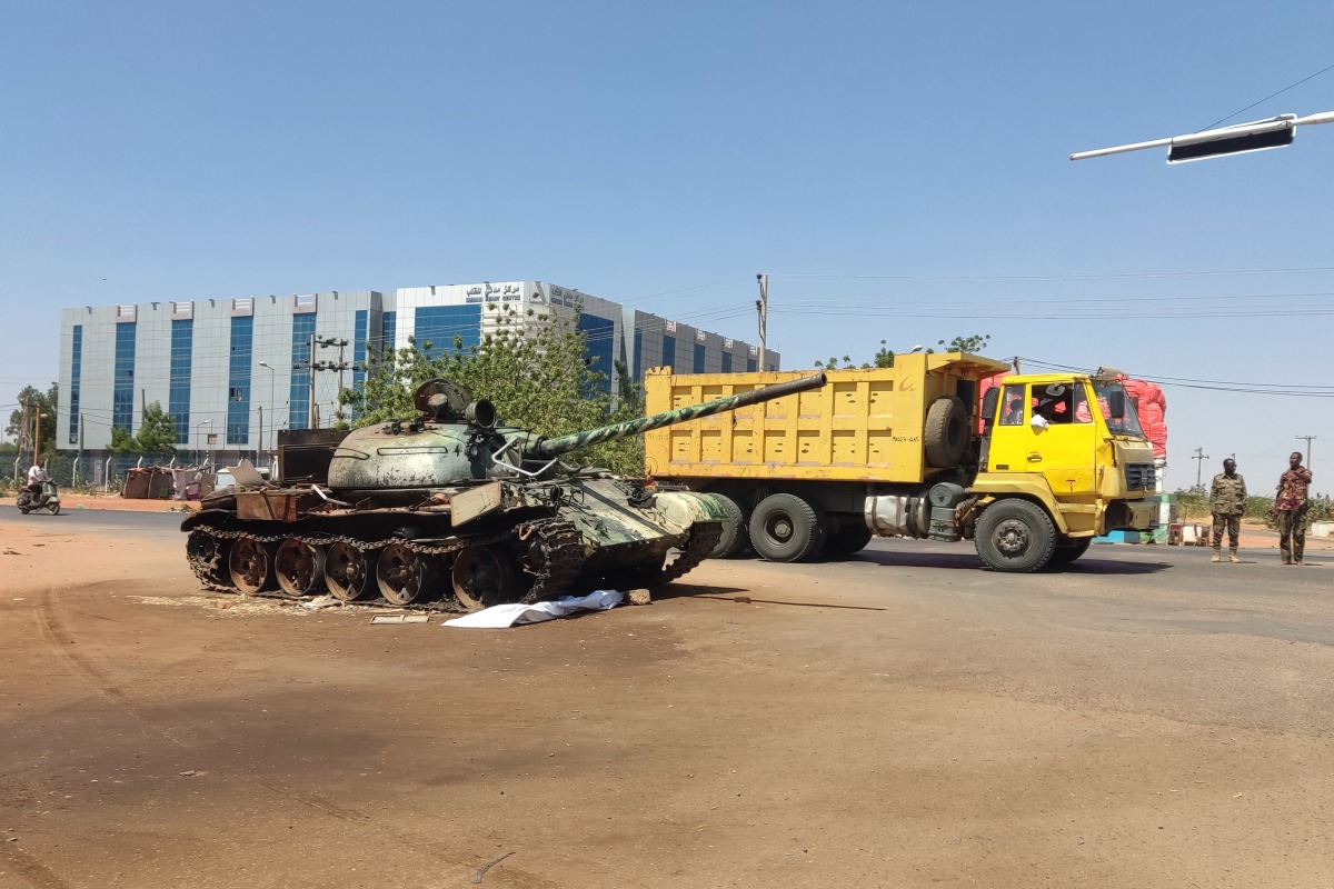 A truck drives past a Sudanese army tank at the entrance of Wad Madani in Sudan's al-Jazira state on February 20, 2025, after the regular army forces reclaimed the area from its rival Rapid Support Forces (RSF) last month. Wad Madani -- the capital of pre-war breadbasket Jazira state -- became a fierce battleground when RSF forces descended on the city in December 2023, forcing hundreds of thousands to flee amid reports of summary executions and systematic violence. (Photo by AFP)
