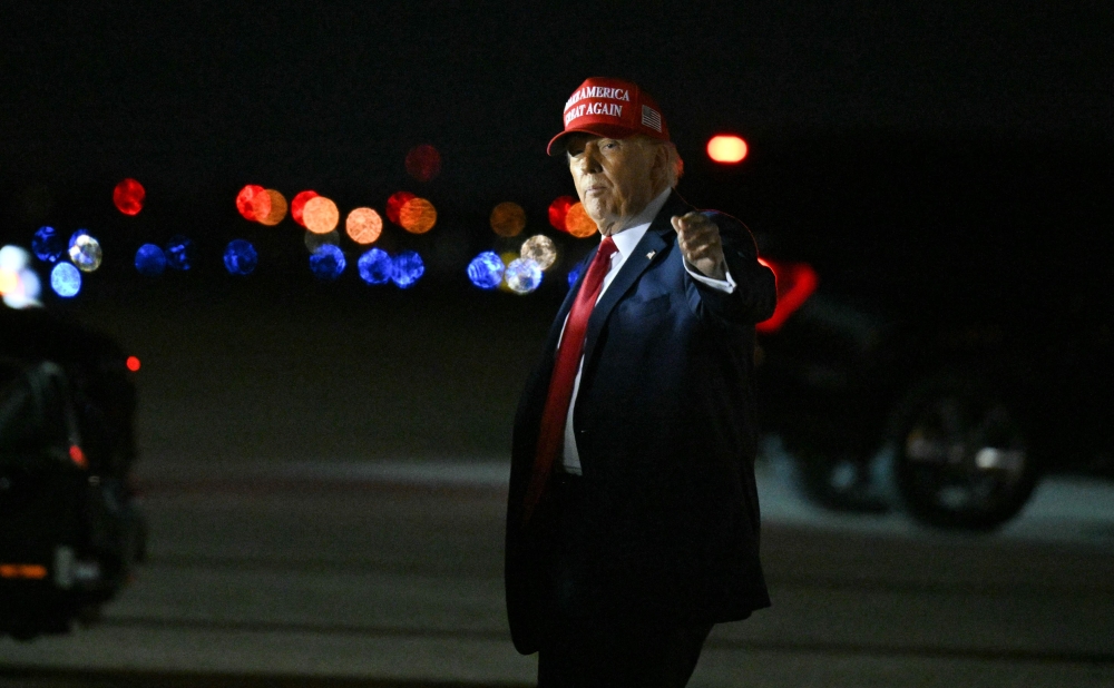 US President Donald Trump gestures after landing at the Palm Beach International Airport in West Palm Beach, Florida, on February 28, 2025. (Photo by Roberto Schmidt / AFP)