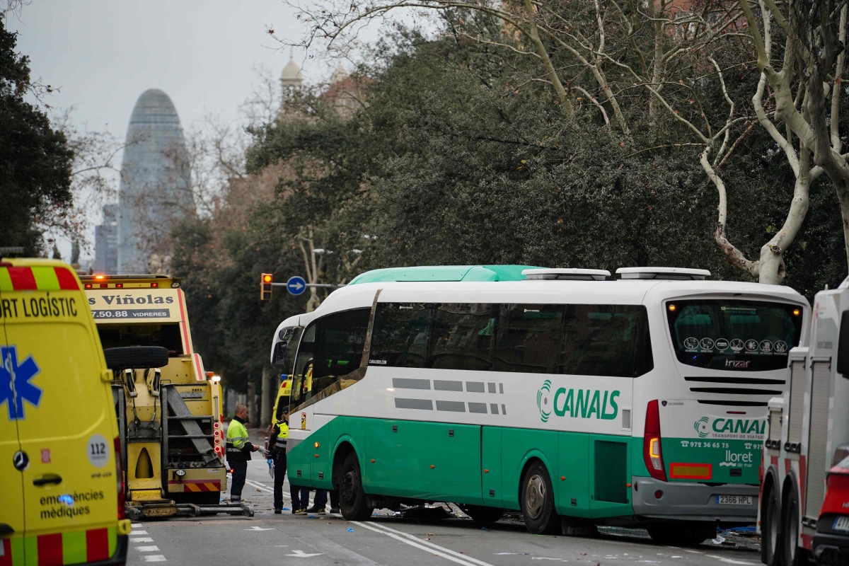 Emergency services members stand next to a bus after two buses collided in Barcelona on March 3, 2025. Photo by Manaure Quintero / AFP