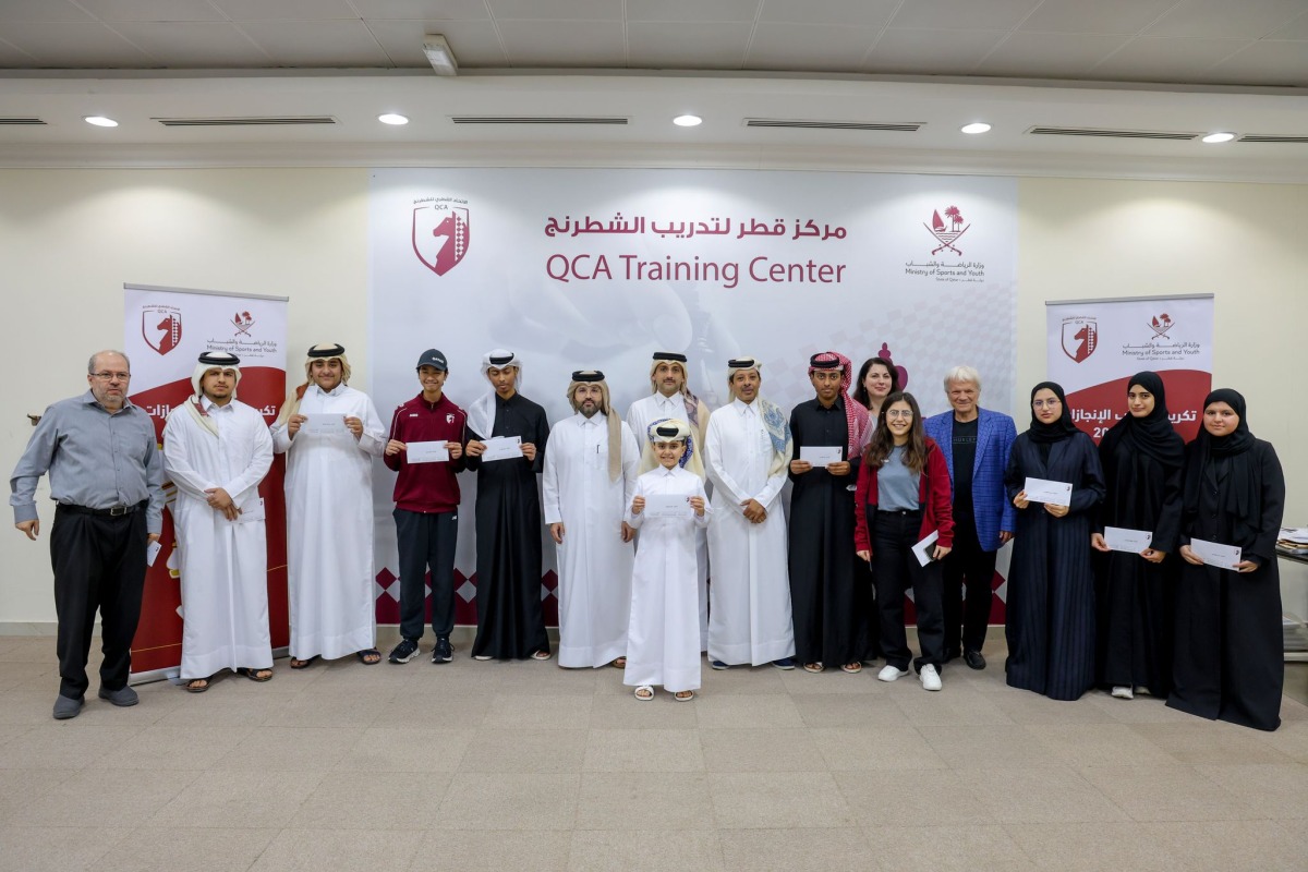 QCA President Mohammed Al Mudhahka poses with players and officials during the felicitation ceremony.