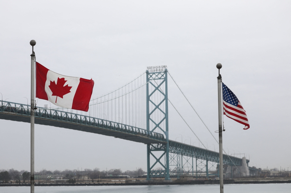 Trucks cross the Ambassador Bridge between Windsor, Canada and Detroit, Michigan on the first day of President Donald Trump's new 25% tariffs on goods from Canada and Mexico on March 4, 2025 in Windsor, Canada. (Photo by Bill Pugliano/Getty Images via AFP)