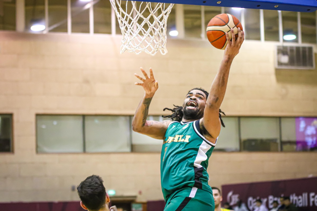 Al Ahli's Raekwon Deshawn Rogers leaps to score.