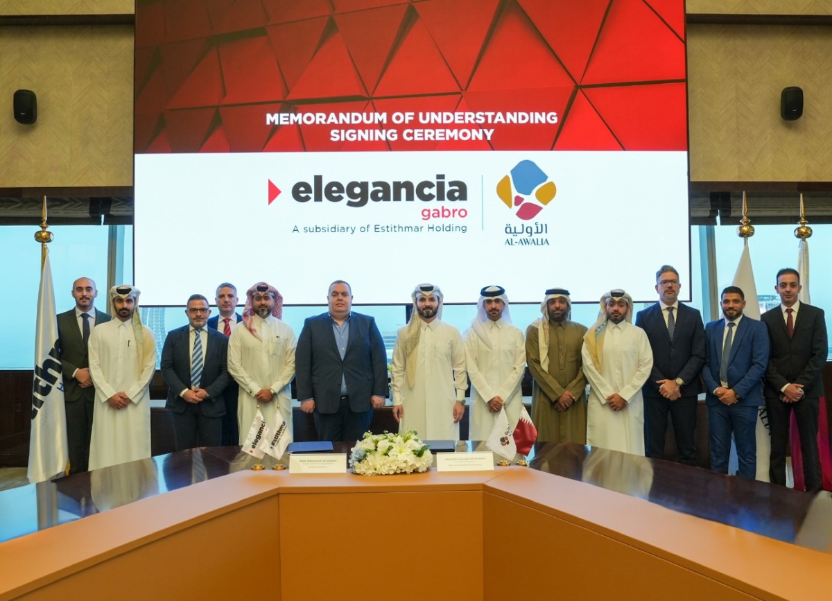 Cluster Chief Executive Officer of Elegancia Services—a subsidiary of Estithmar Holding, Abd Almunem Al Sakka and Commercial Director at Qatar Primary Materials Company, Abdullah Hassan Al Kuwari with other officials during the signing of MoU.