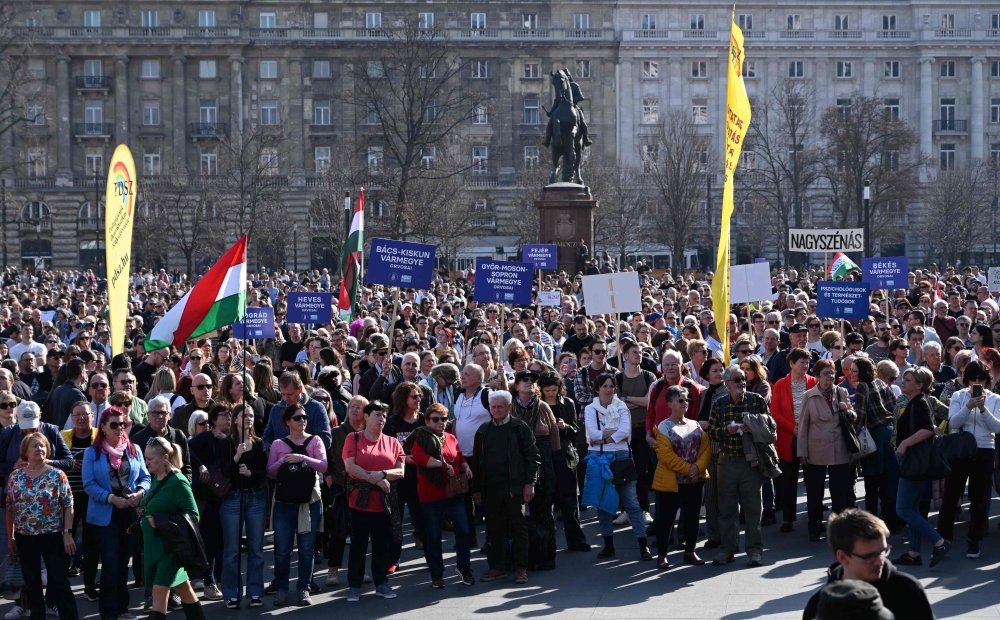 Hungarian doctors and other healthcare workers gather to protest against the health policy of Hungary's Prime Minister Orban's government in front of the Hungarian Parliament in Budapest on March 8, 2025. (Photo by Attila Kisbenedek / AFP)