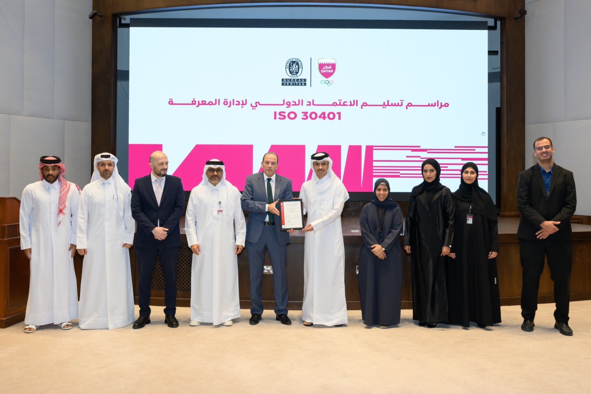 Officials receiving the certification during a ceremony.