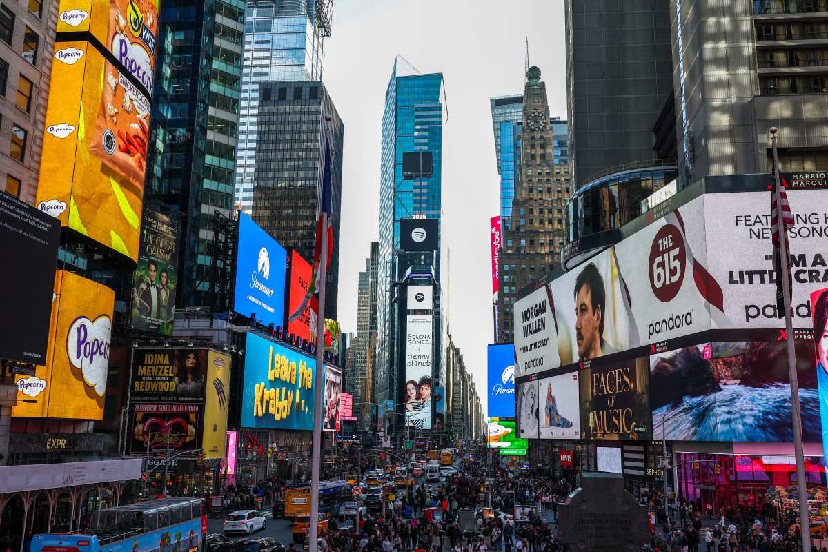 Pedestrians and cars move through the Times Square district of Manhattan, New York, on March 22, 2025. (Photo by CHARLY TRIBALLEAU / AFP)
