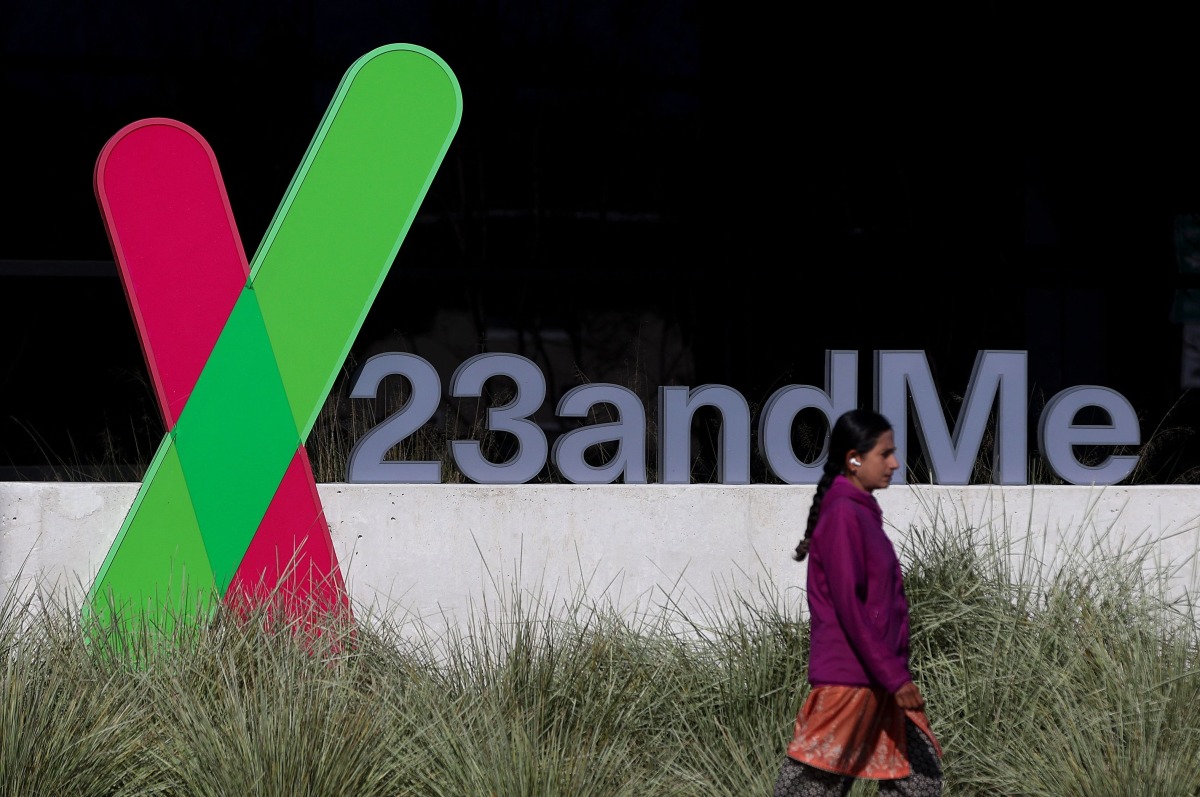 (FILES) A pedestrian walks by a sign posted in front of the 23andMe headquarters on February 1, 2024 in Sunnyvale, California. (Photo by JUSTIN SULLIVAN / GETTY IMAGES NORTH AMERICA / AFP)
