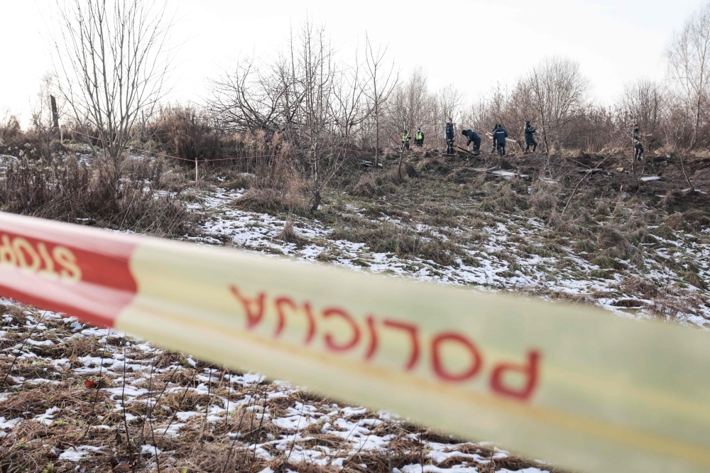 Lithuanian police search the area where a DHL cargo plane crashed near the Vilnius International Airport in Vilnius on November 25, 2024. Photo by Petras Malukas / AFP

