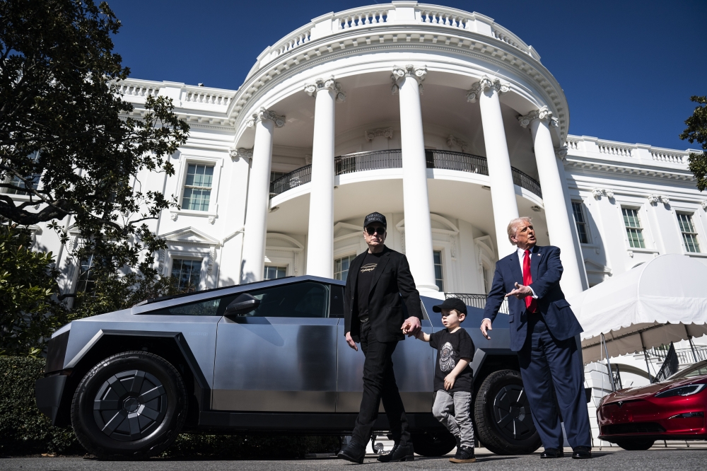 President Donald Trump and Tesla CEO Elon Musk speak to reporters while looking at various models of the company's vehicles on the South Lawn of White House on March 11, 2025. (Photo by Jabin Botsford/The Washington Post)
