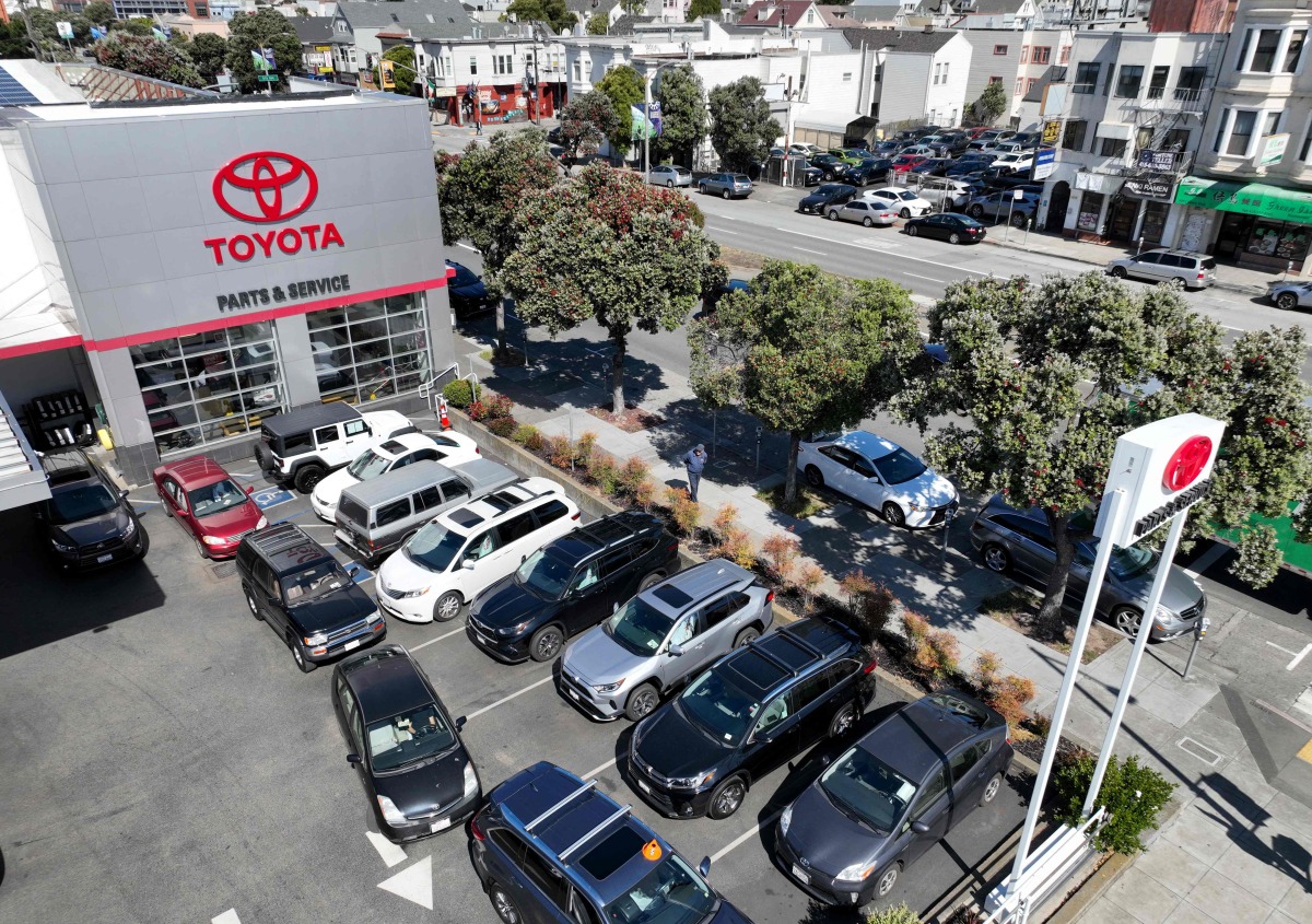 (FILES) In an aerial view, cars sit in a lot at the San Francisco Toyota service center on May 11, 2022 in San Francisco, California. (Photo by JUSTIN SULLIVAN / GETTY IMAGES NORTH AMERICA / AFP)
