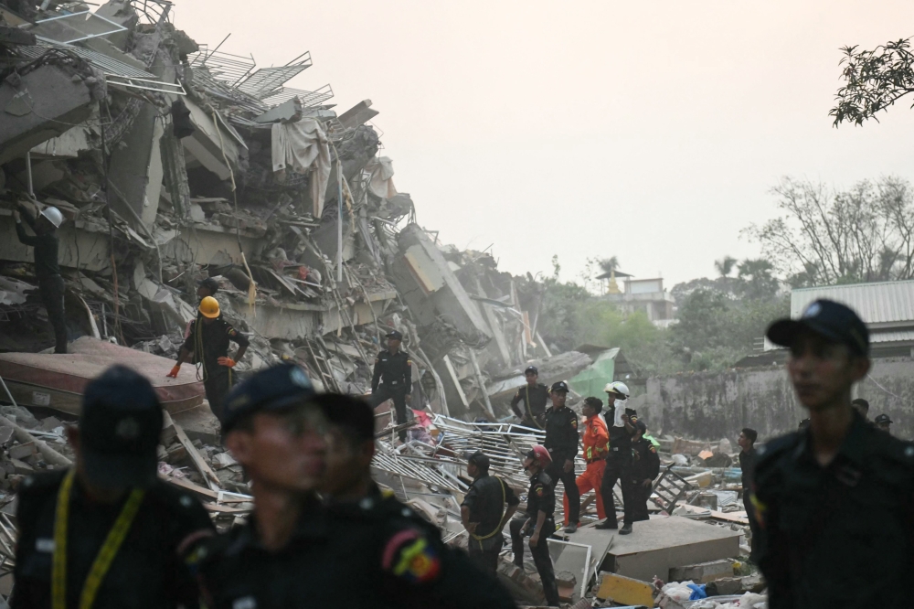 Rescuers search for survivors amid the rubble of the collapsed Sky Villa Condominium building in Mandalay on March 29, 2025. (Photo by Sai Aung MAIN / AFP)