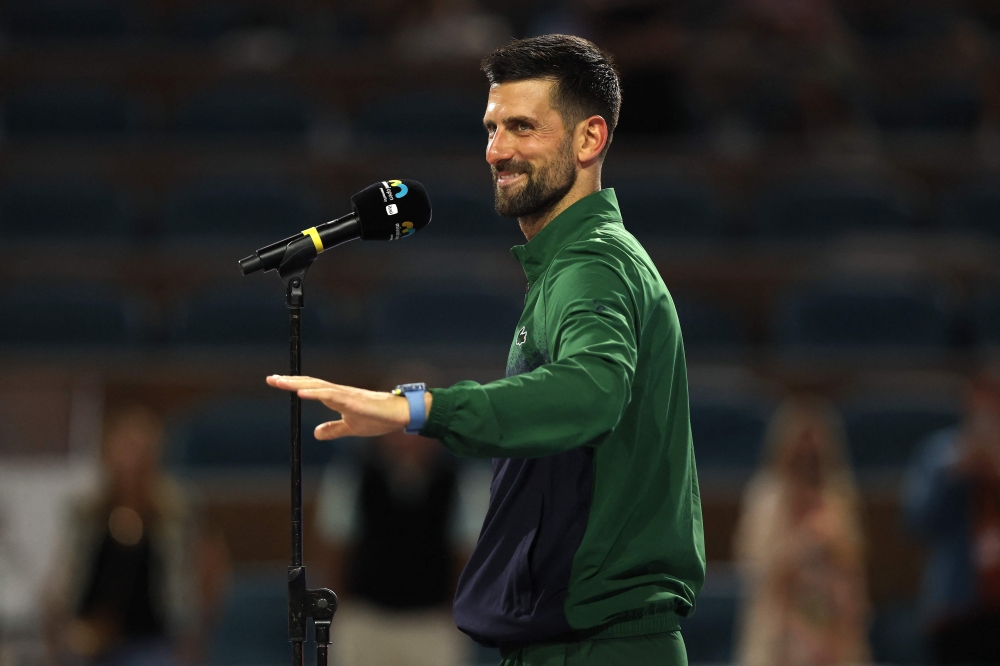 Novak Djokovic of Serbia speaks after losing to Jakub Mensik of the Czech Republic during the men's singles final on the final day of the Miami Open Presented by Itau 2025 at Hard Rock Stadium on March 30, 2025 in Miami Gardens, Florida. Matthew Stockman/Getty Images/AFP