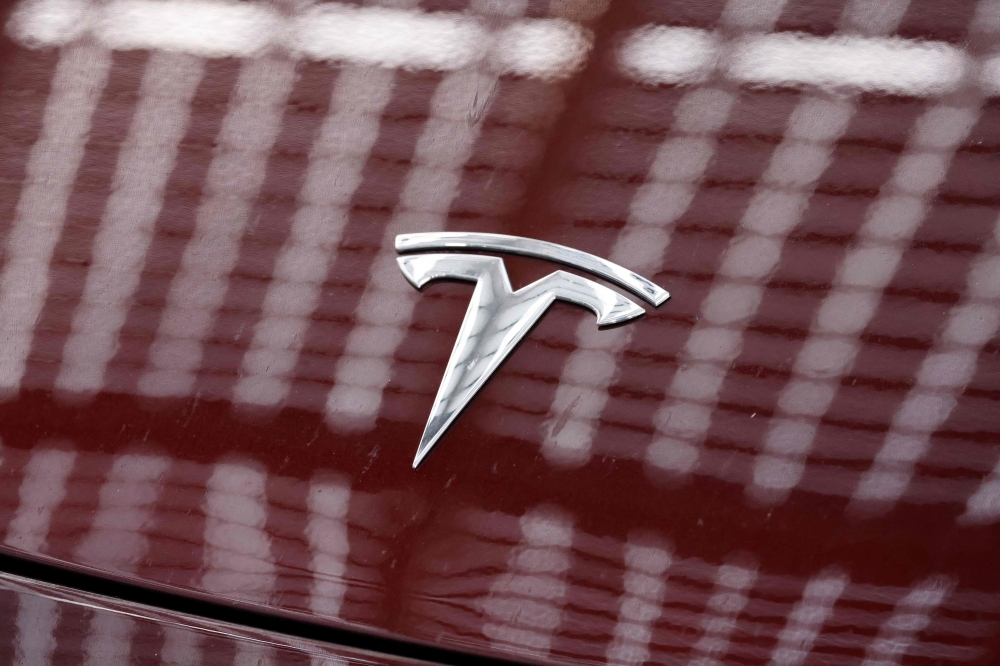 The Tesla logo is pictured on a car outside the US carmaker Tesla's German factory near Berlin, on November 20, 2024 in Gruenheide, eastern Germany. (Photo by Odd Andersen / AFP)