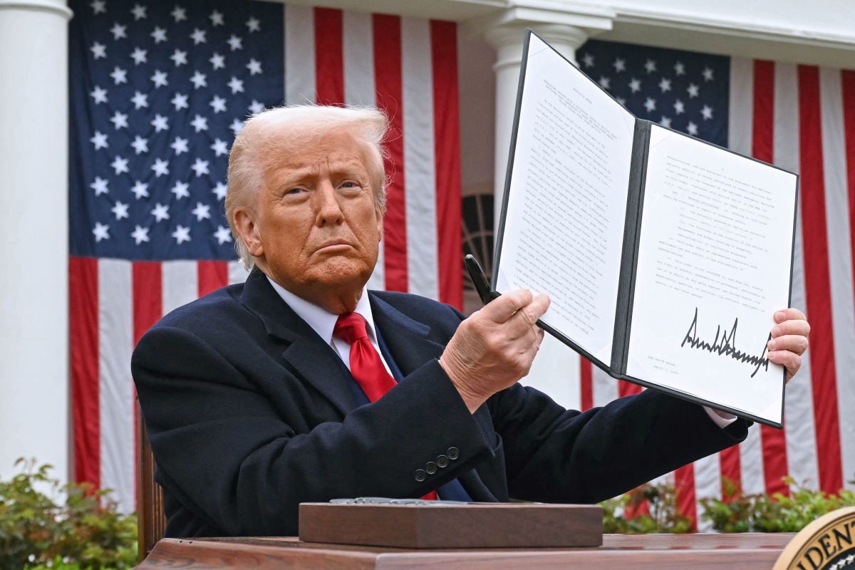 US President Donald Trump holds a signed executive order after delivering remarks on reciprocal tariffs during an event in the Rose Garden entitled 